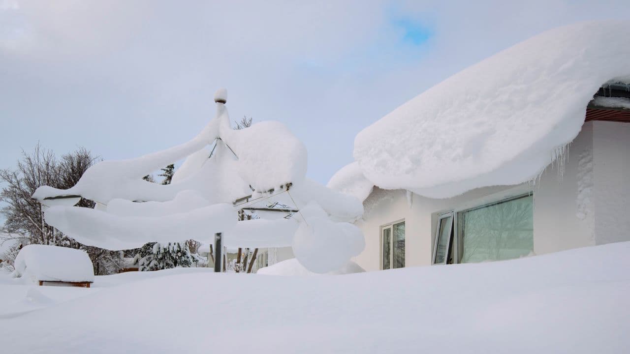 Houses buried under deep snow after a heavy winter storm