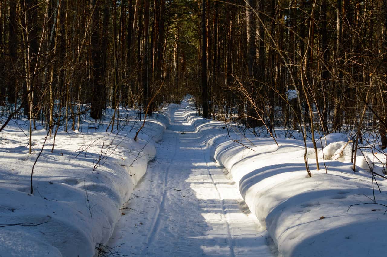 A powered snow tool clearing a narrow path through fresh snow