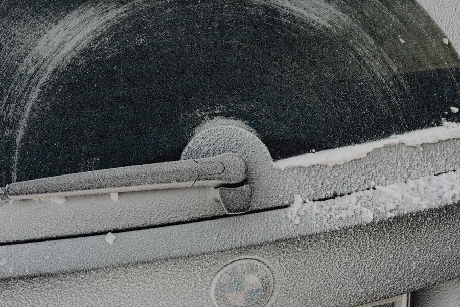 Close-up of a frosty car window on a winter morning
